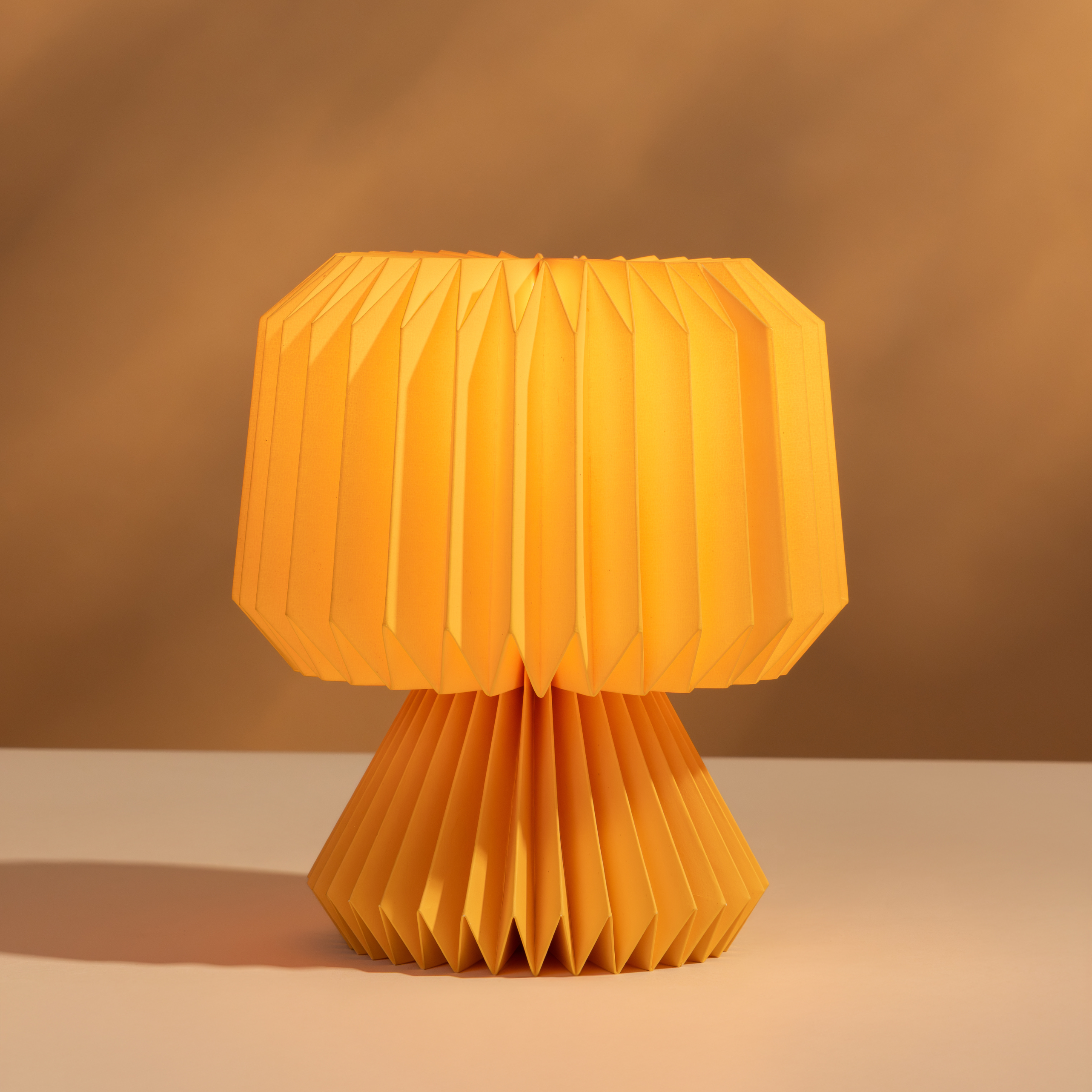 Yellow origami-style lamp on a beige surface with a brown background