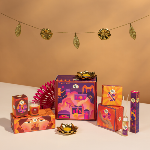 Decorative Diwali gift set with colorful boxes and candles on a beige background