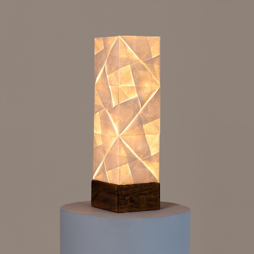 Solobe Tetris - a Geometrically patterned Table lamp on a gray pedestal against a brown background