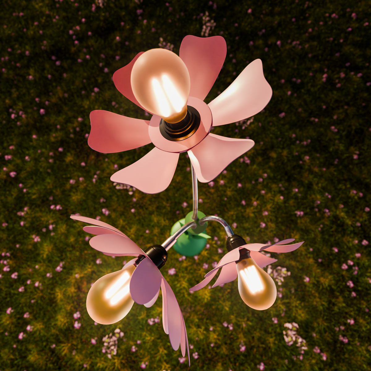 A whimsical flower-shaped outdoor light fixture with three glowing warm bulbs, set against a dark grassy background with small pink flowers.