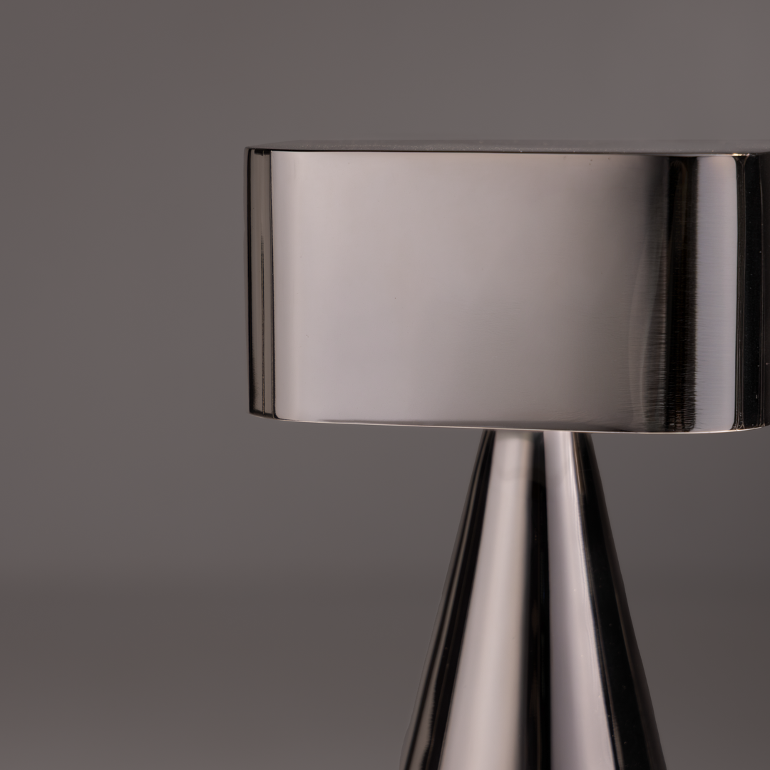 Illustration highlighting modern chrome table lamp creating warm ambient lighting for bedroom and living space