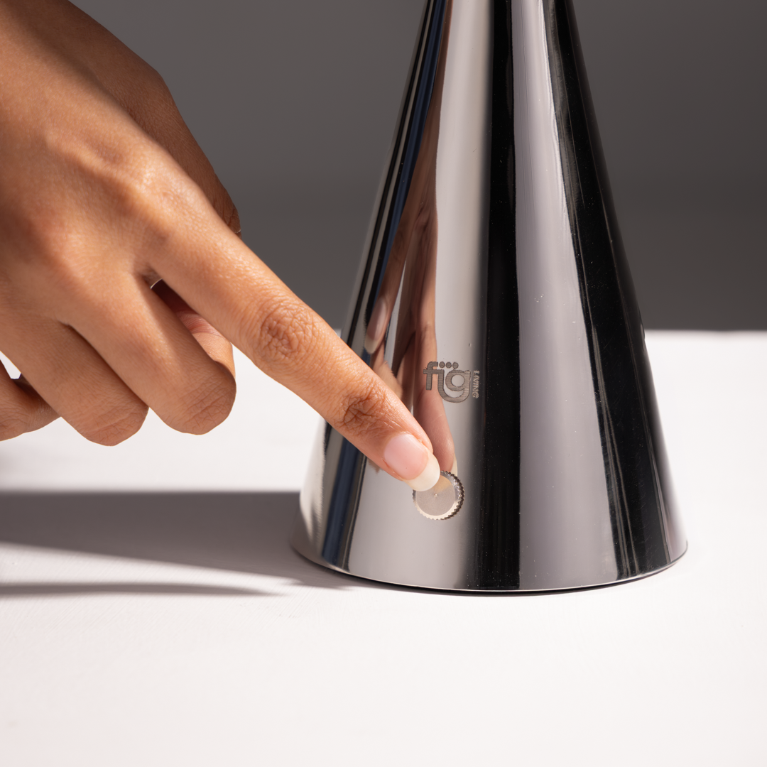 Illustration featuring premium chrome portable lamp with reflective steel body and minimalist aesthetic